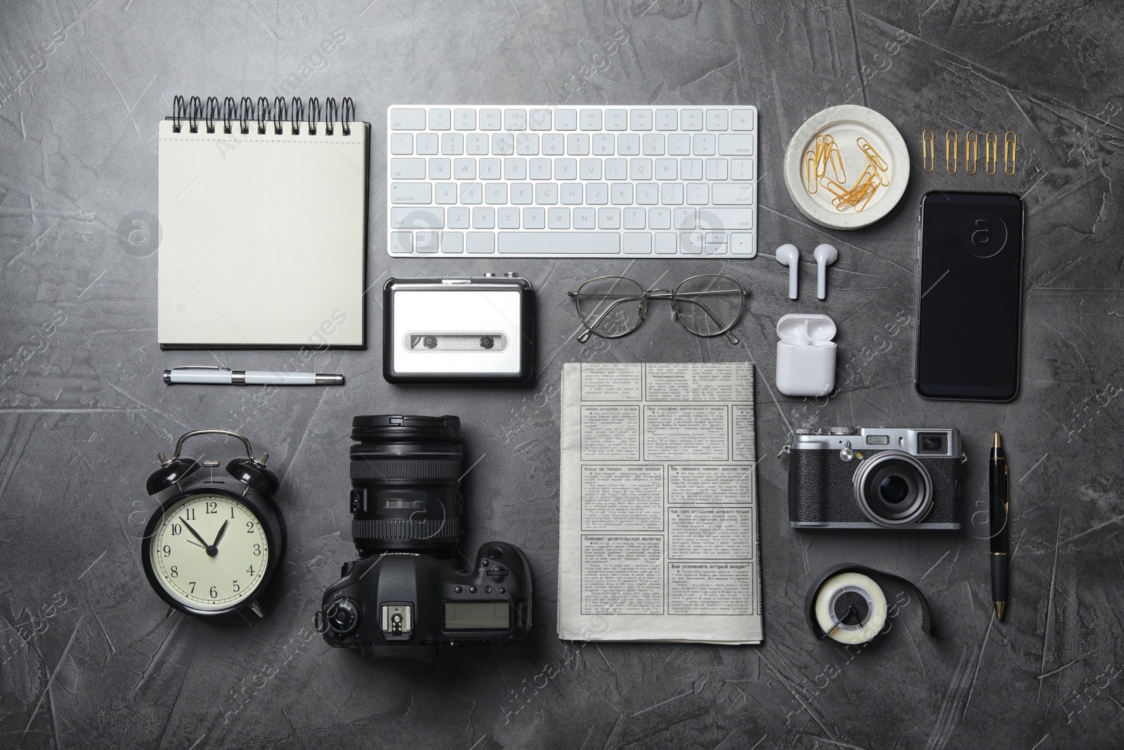 Photo of Flat lay composition with equipment for journalist on grey table