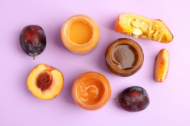 Flat lay composition with healthy baby food and ingredients on violet background