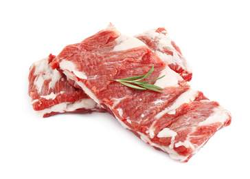 Raw ribs with rosemary on white background