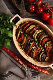 Photo of Delicious ratatouille and ingredients on table, flat lay