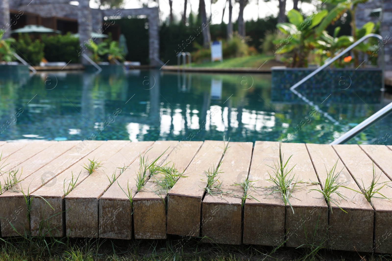 Photo of Outdoor swimming pool with wooden deck at resort