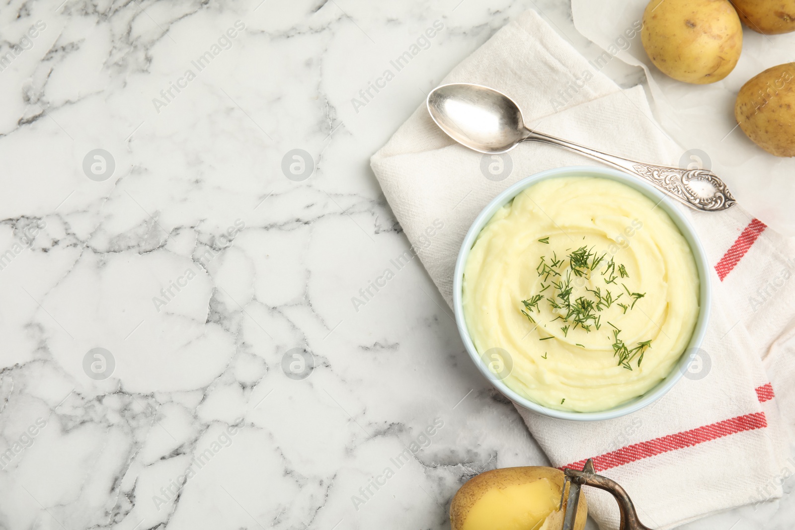 Photo of Freshly cooked homemade mashed potatoes and raw vegetables on white marble table, flat lay. Space for text