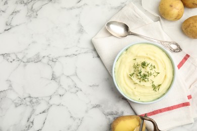 Photo of Freshly cooked homemade mashed potatoes and raw vegetables on white marble table, flat lay. Space for text