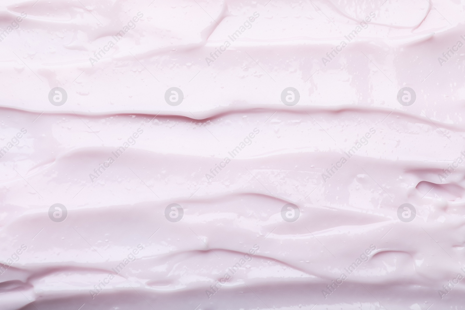 Photo of Closeup view of light pink body cream as background