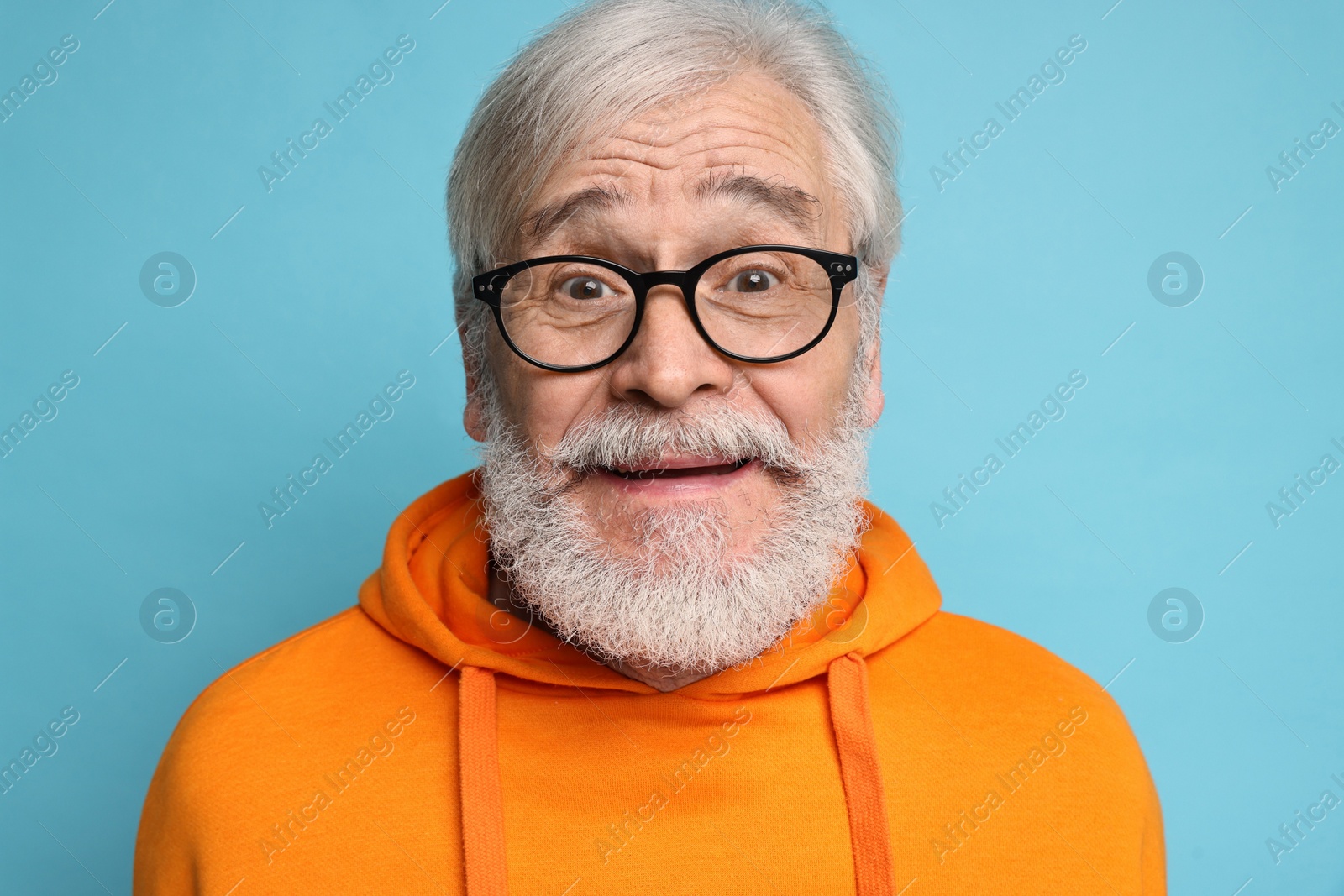 Photo of Senior man with mustache on light blue background