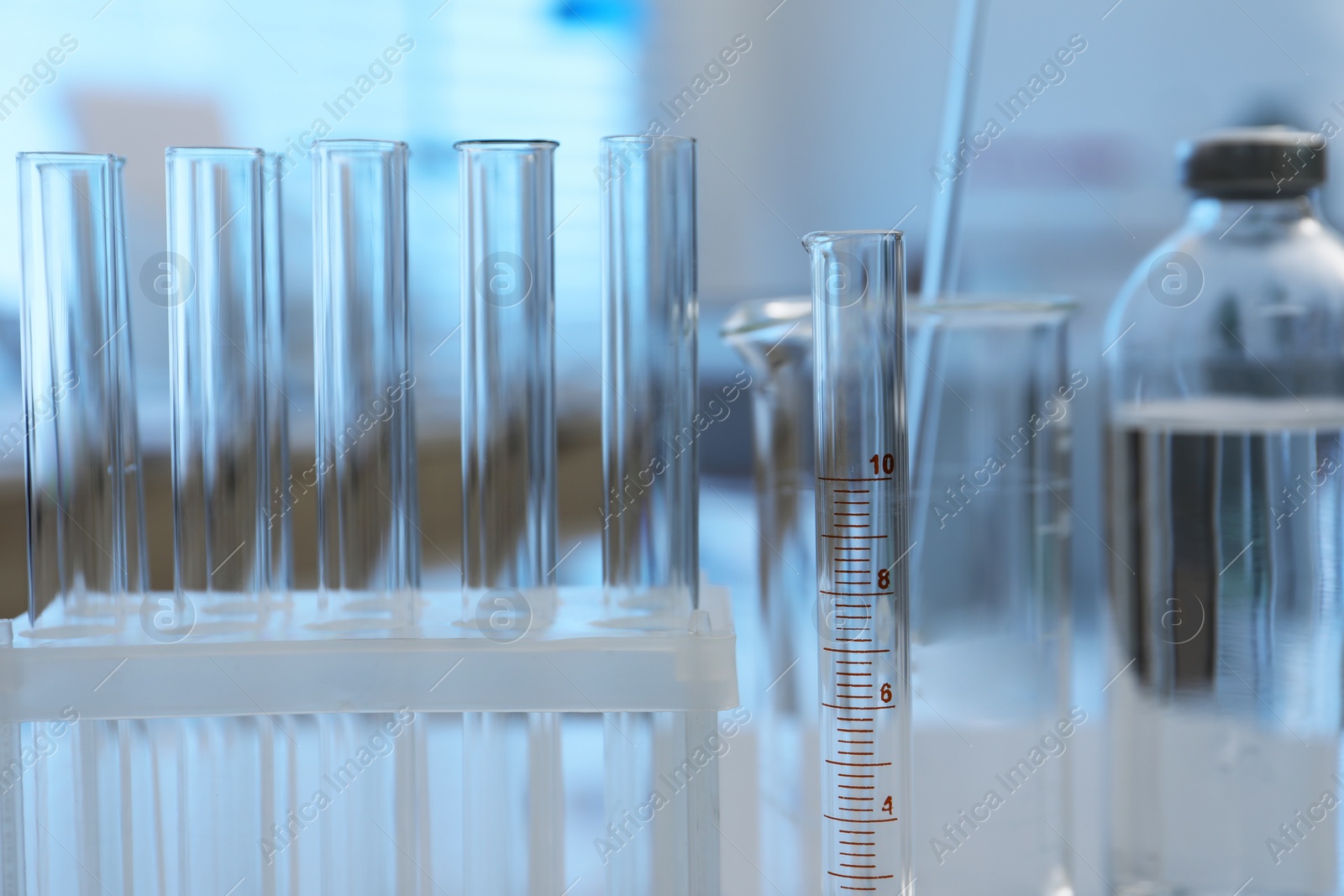 Photo of Laboratory analysis. Different glassware on white table indoors, closeup