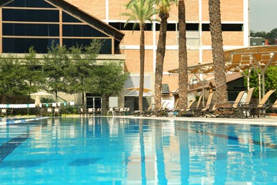 Swimming pool and sunbeds at luxury resort