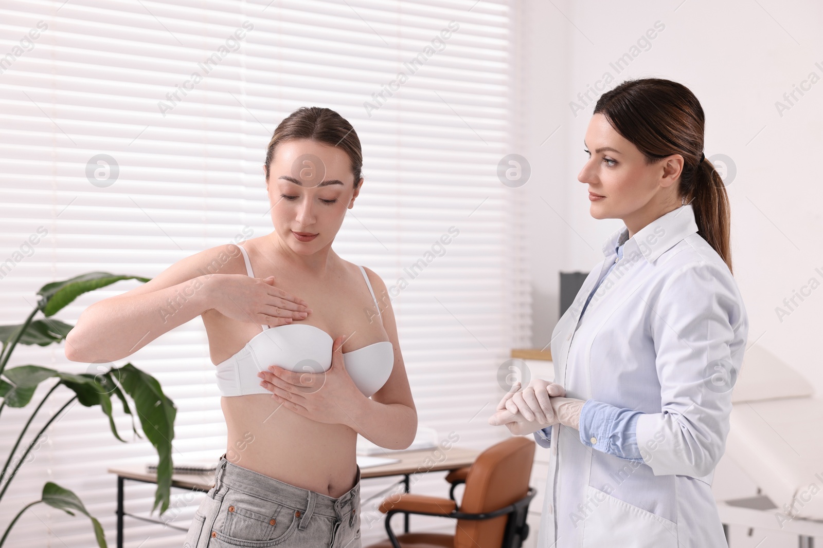 Photo of Mammologist checking young woman's breast in hospital