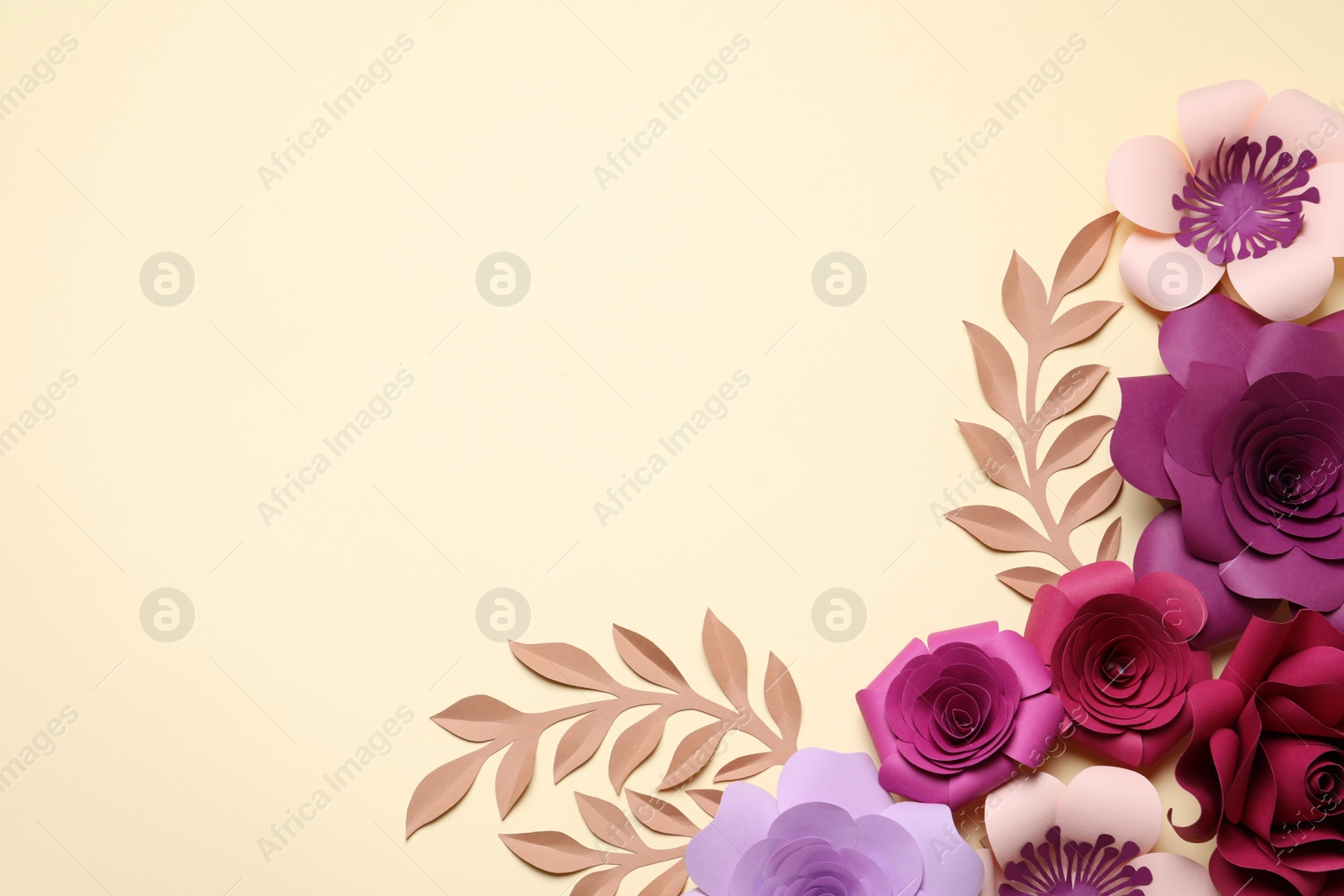 Photo of Different beautiful flowers and branches made of paper on beige background, flat lay. Space for text