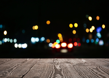 Image of Empty wooden surface against blurred lights. Bokeh effect 