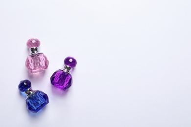Composition with bottles of perfume on white background, top view