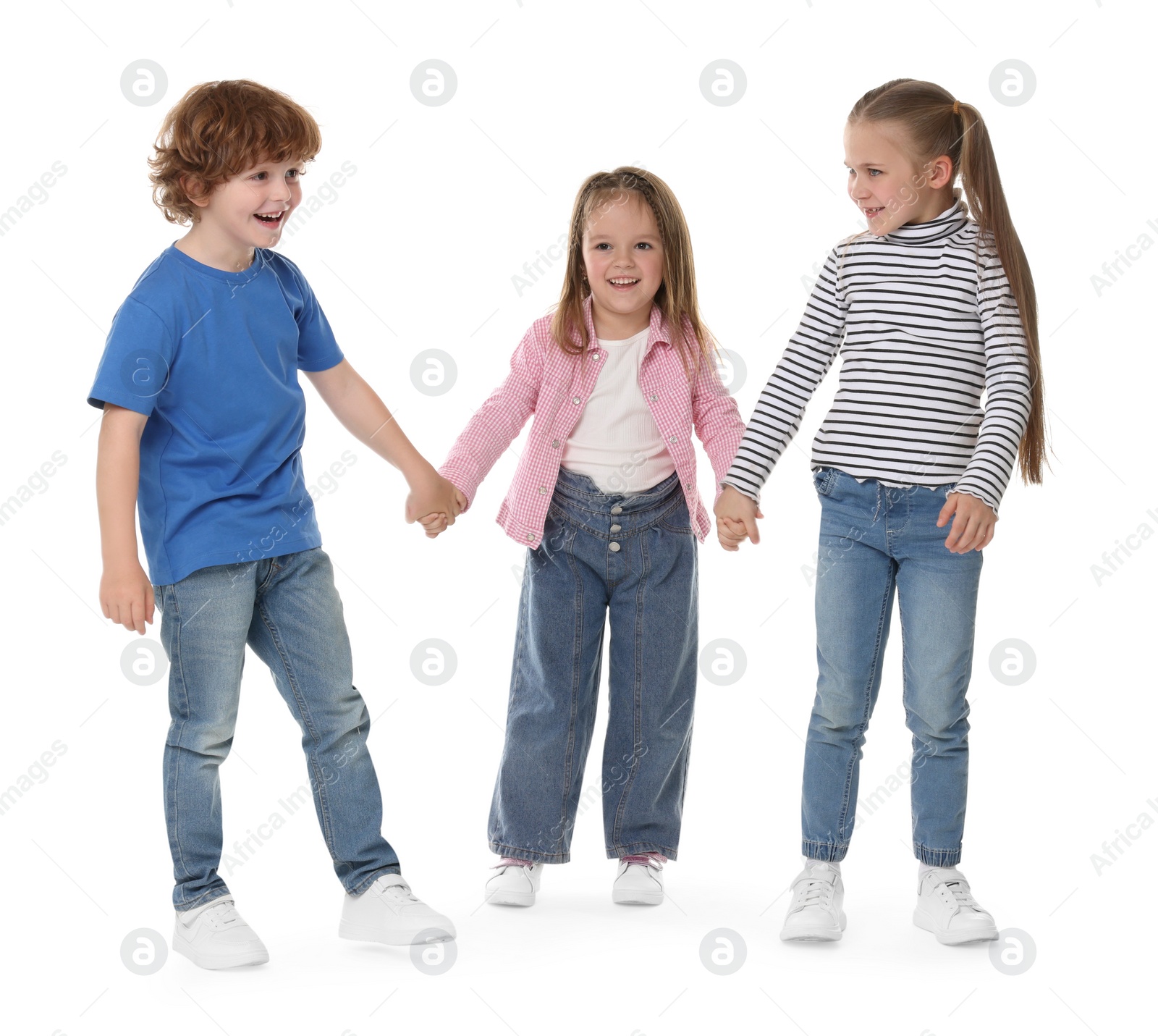 Photo of Group of cute children holding hands on white background