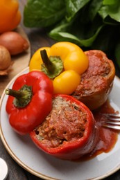 Photo of Delicious stuffed bell peppers served on wooden table