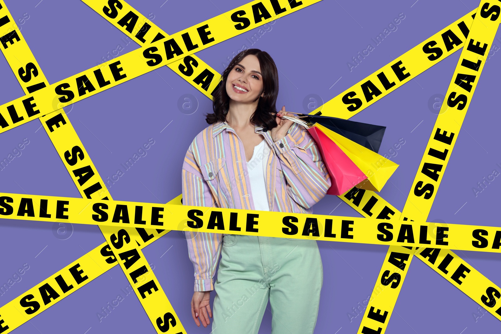 Image of Sale. Happy young woman with shopping bags surrounded by yellow tape on violet background