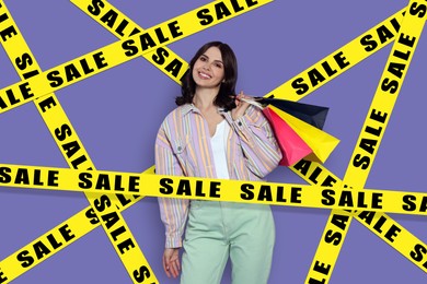 Sale. Happy young woman with shopping bags surrounded by yellow tape on violet background