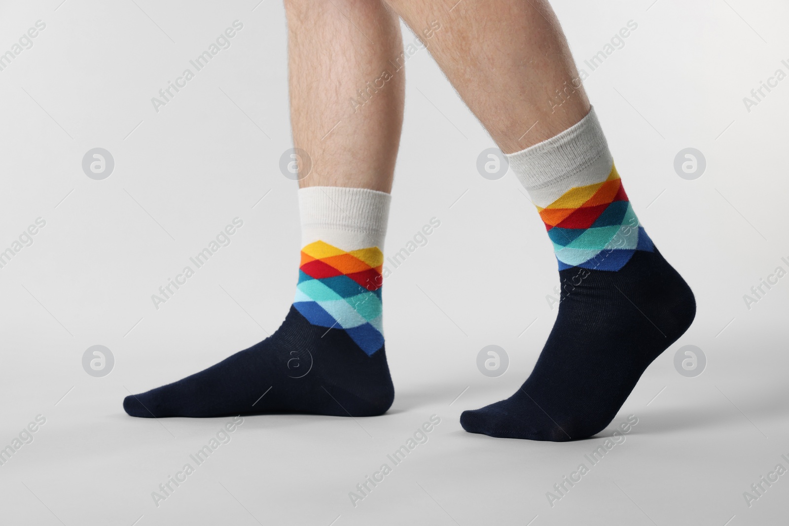 Photo of Man in stylish colorful socks on white background, closeup