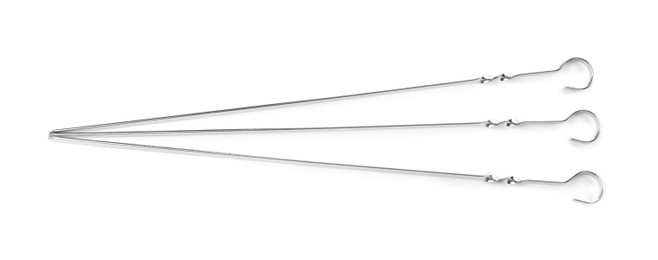 Photo of Metal skewers on white background, top view. Barbecue utensil