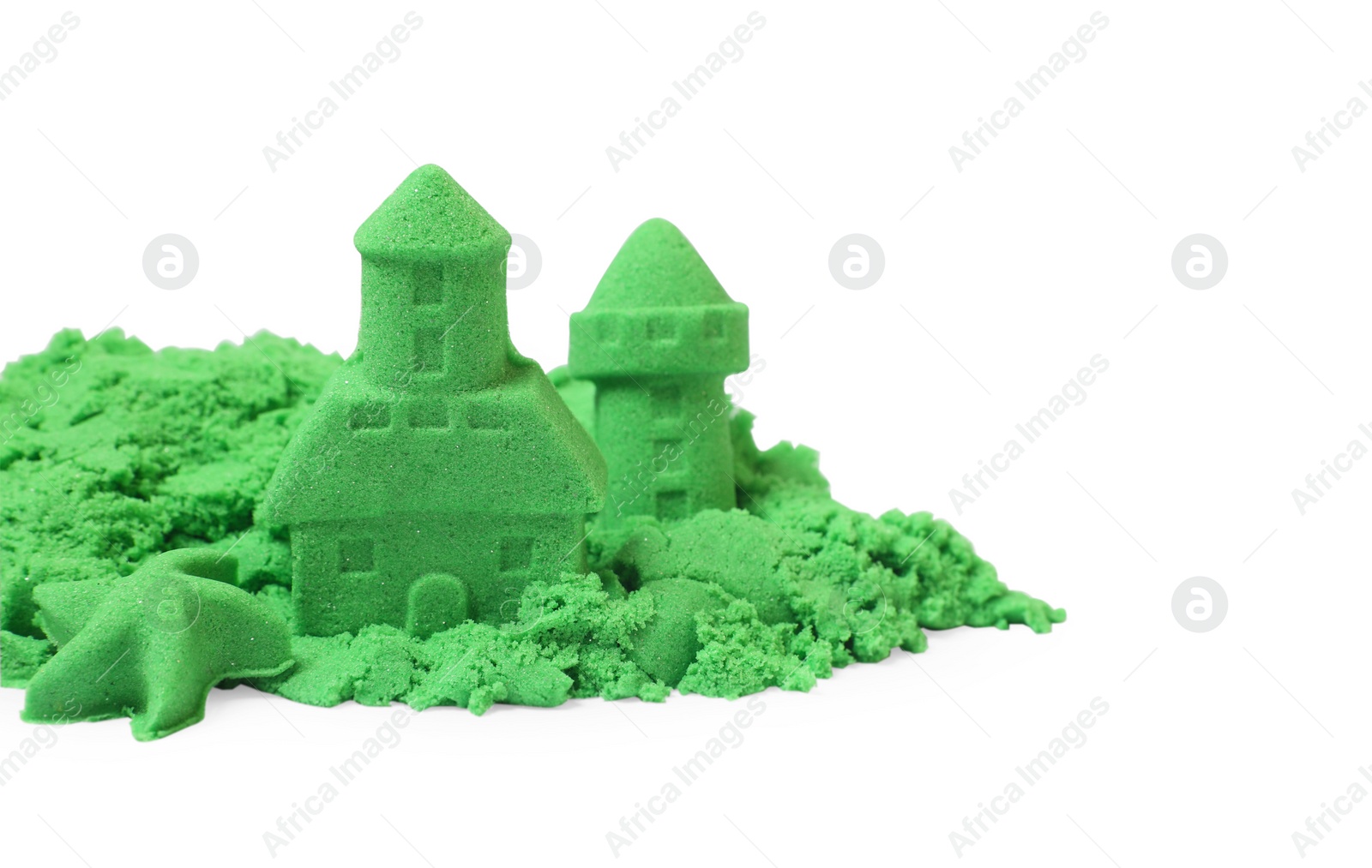 Photo of Castle figures and starfish made of green kinetic sand isolated on white