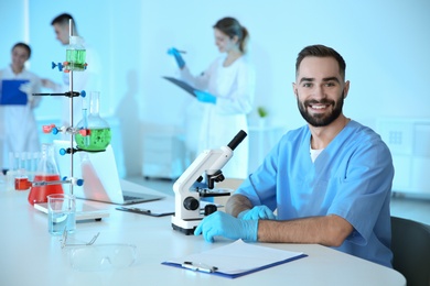 Photo of Portrait of medical student working in scientific laboratory. Space for text