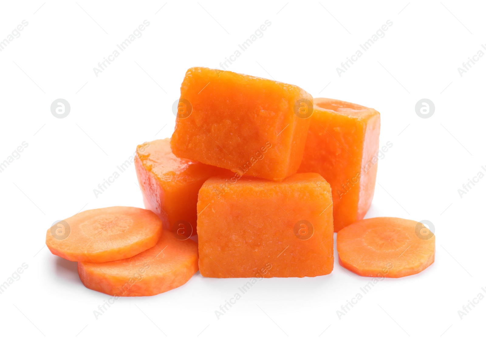 Photo of Frozen carrot puree cubes and fresh carrot isolated on white