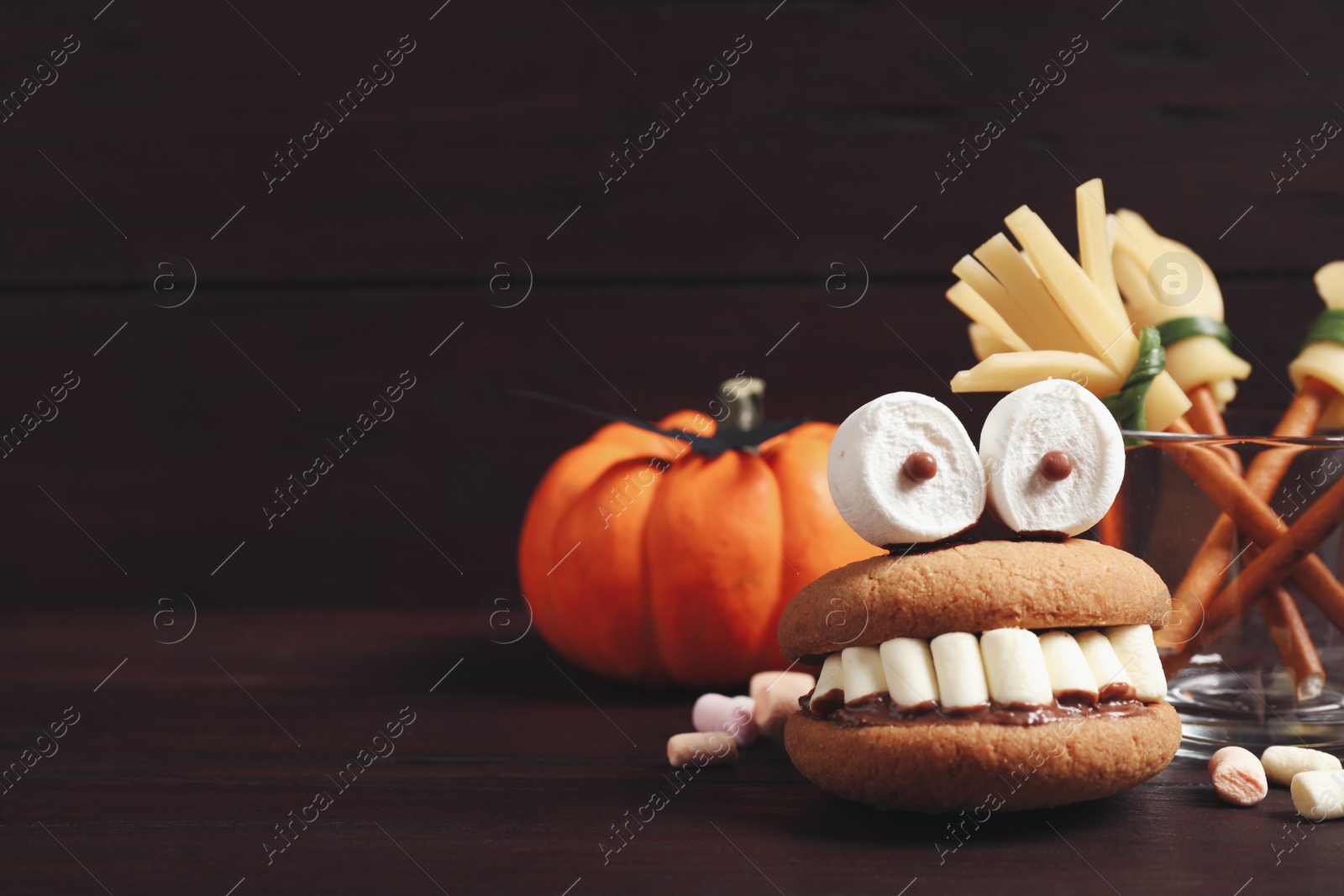 Photo of Delicious Halloween themed dessert on wooden table. Space for text