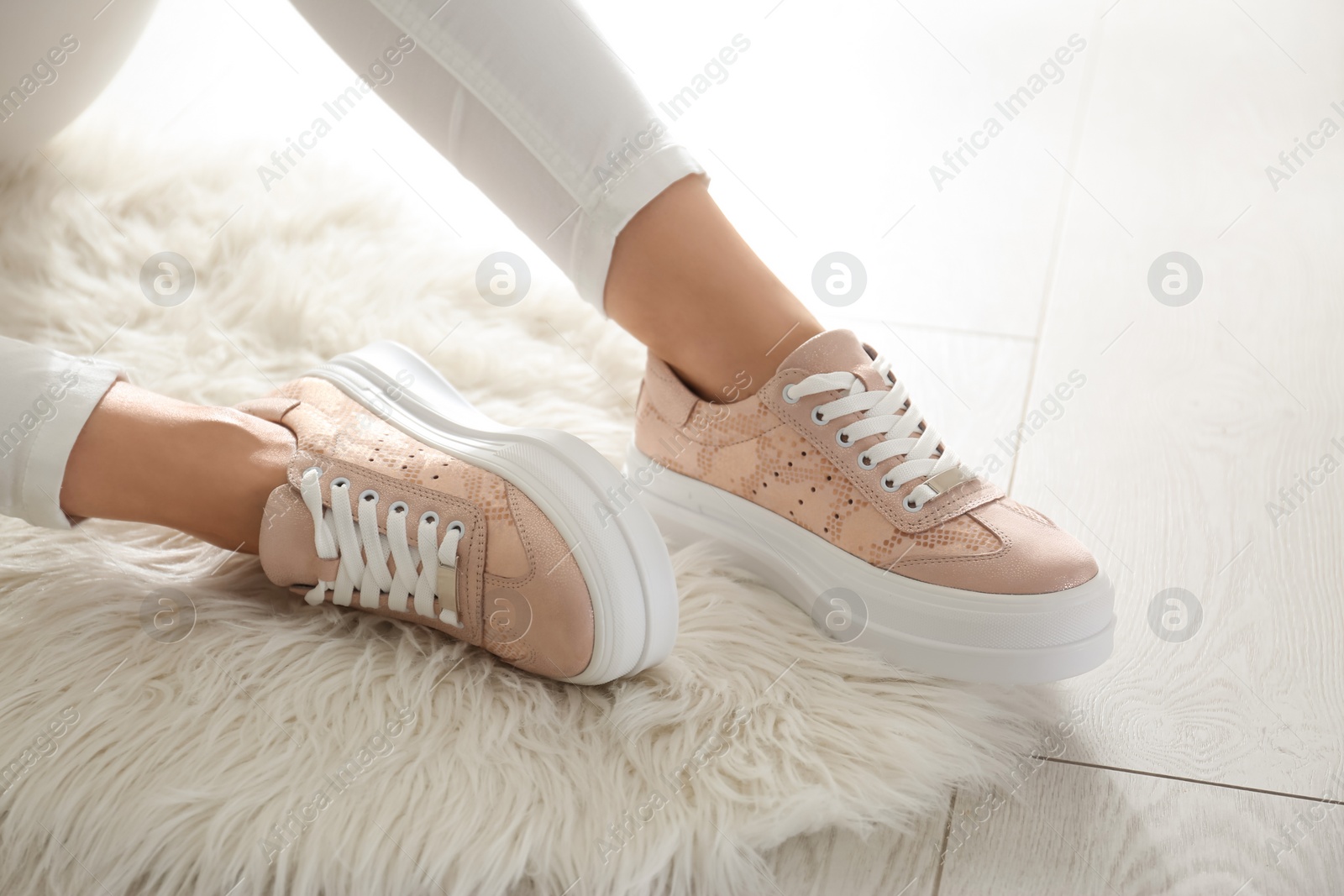 Photo of Woman wearing comfortable stylish shoes indoors, closeup