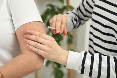 Diabetes. Woman getting insulin injection indoors, closeup