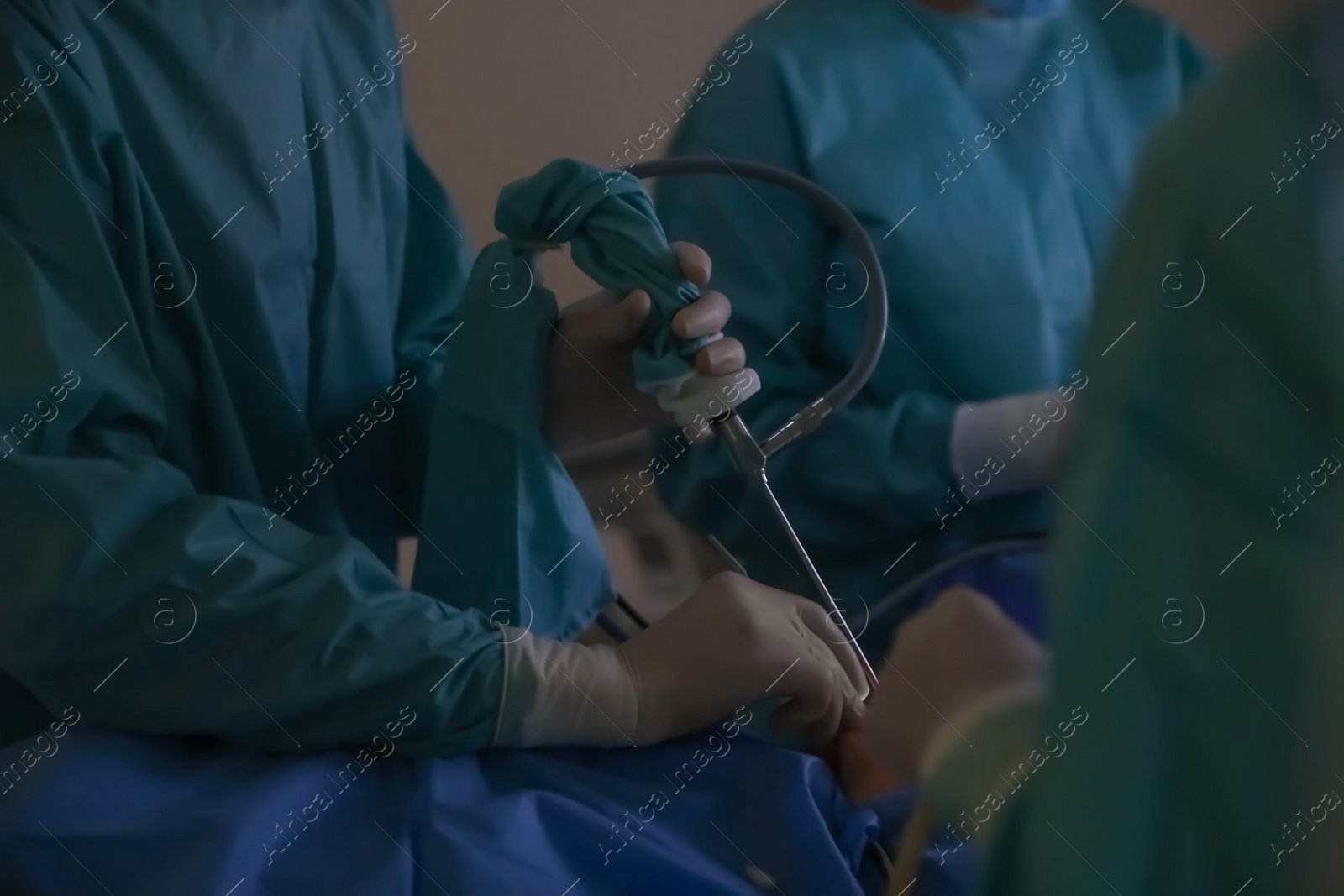 Photo of Professional doctors performing 
operation in surgery room, closeup