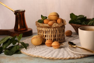 Aromatic walnut shaped cookies, mint and coffee on table. Homemade pastry filled with caramelized condensed milk