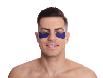 Man with blue under eye patches on white background