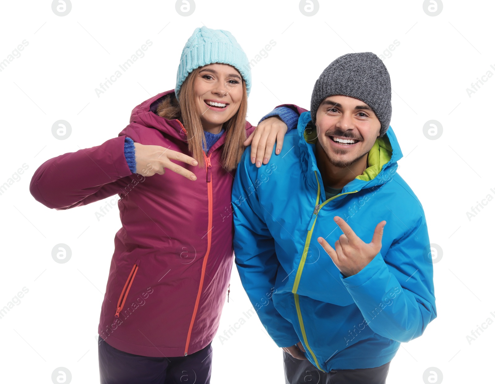 Photo of Young couple wearing warm clothes on white background. Ready for winter vacation