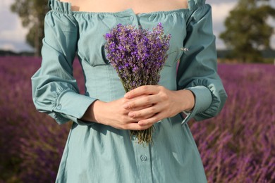 Photo of Woman with bouquet of lavender outdoors, closeup