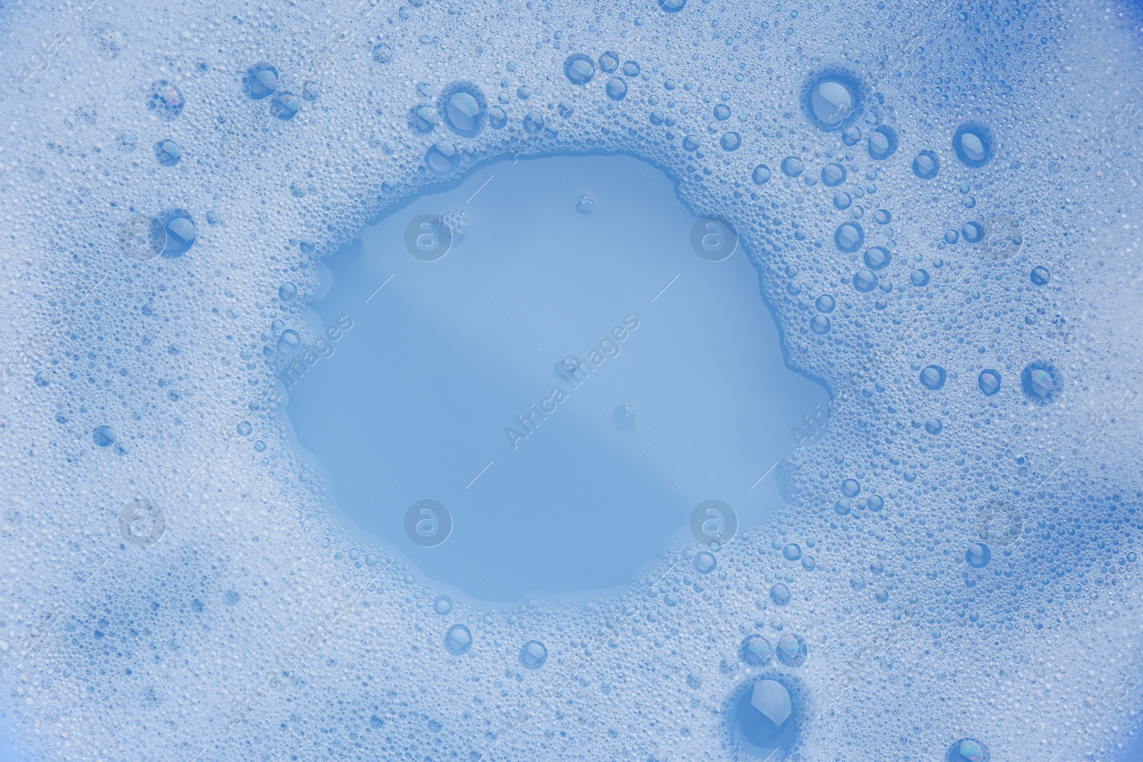 Photo of Water impregnated with soap, top view. Hand washing laundry