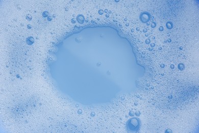 Photo of Water impregnated with soap, top view. Hand washing laundry