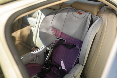 Empty modern child safety seat inside car