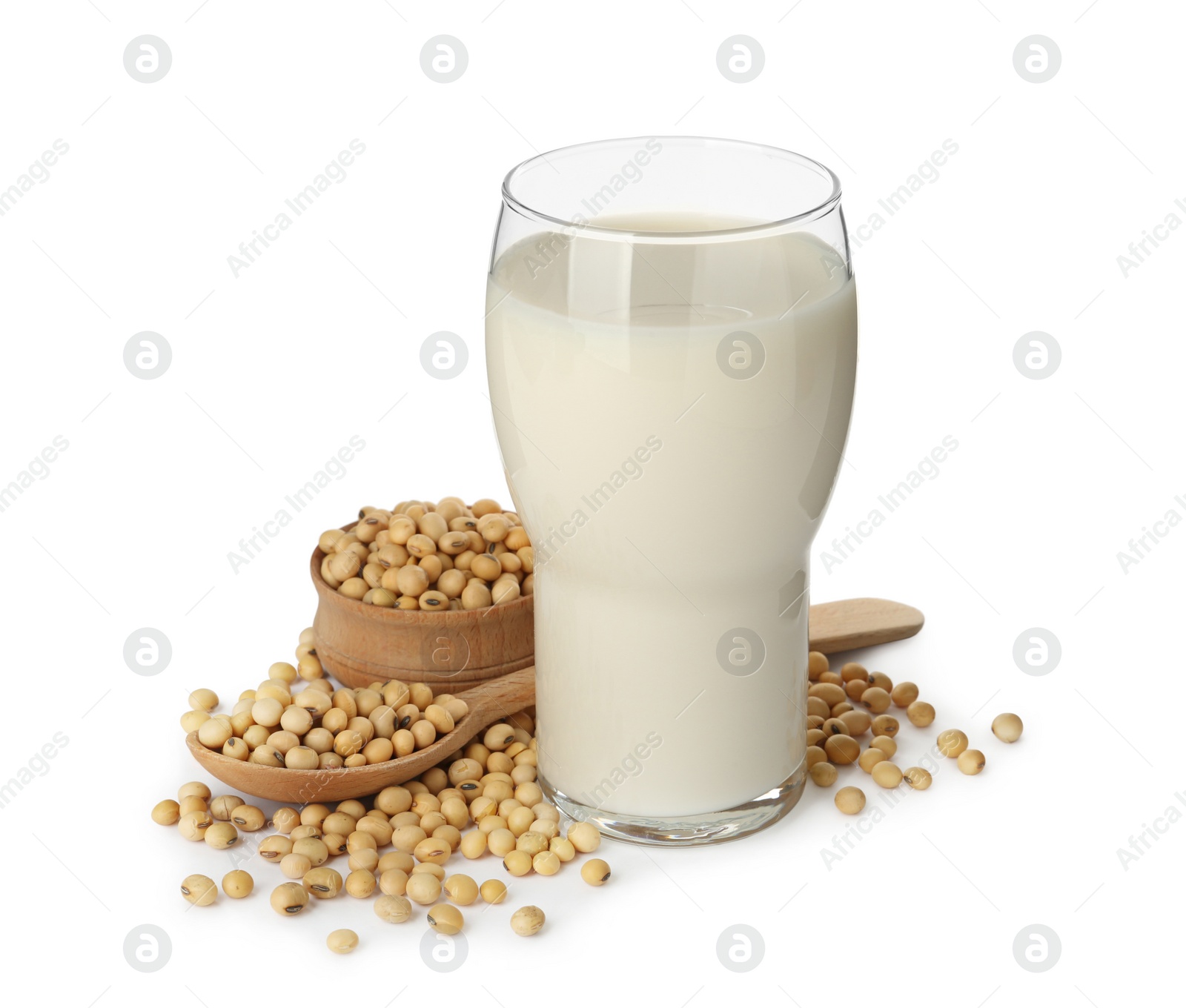 Photo of Glass of fresh soy milk and beans on white background