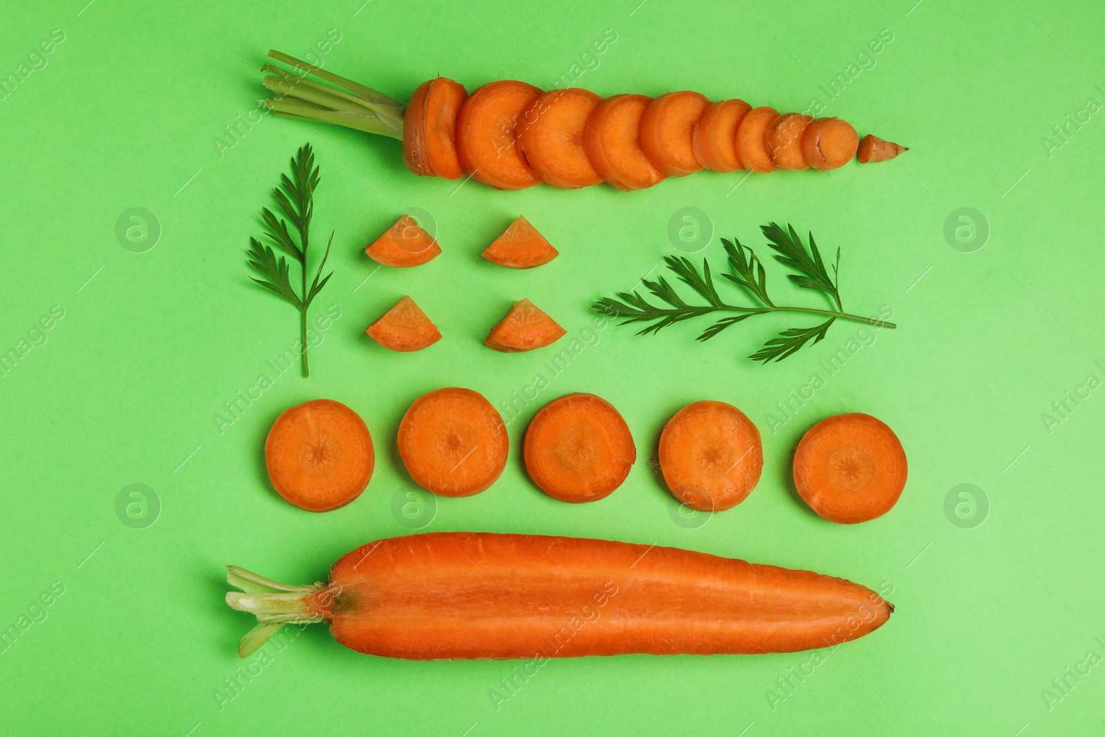 Photo of Creative flat lay composition with fresh ripe carrots on color background