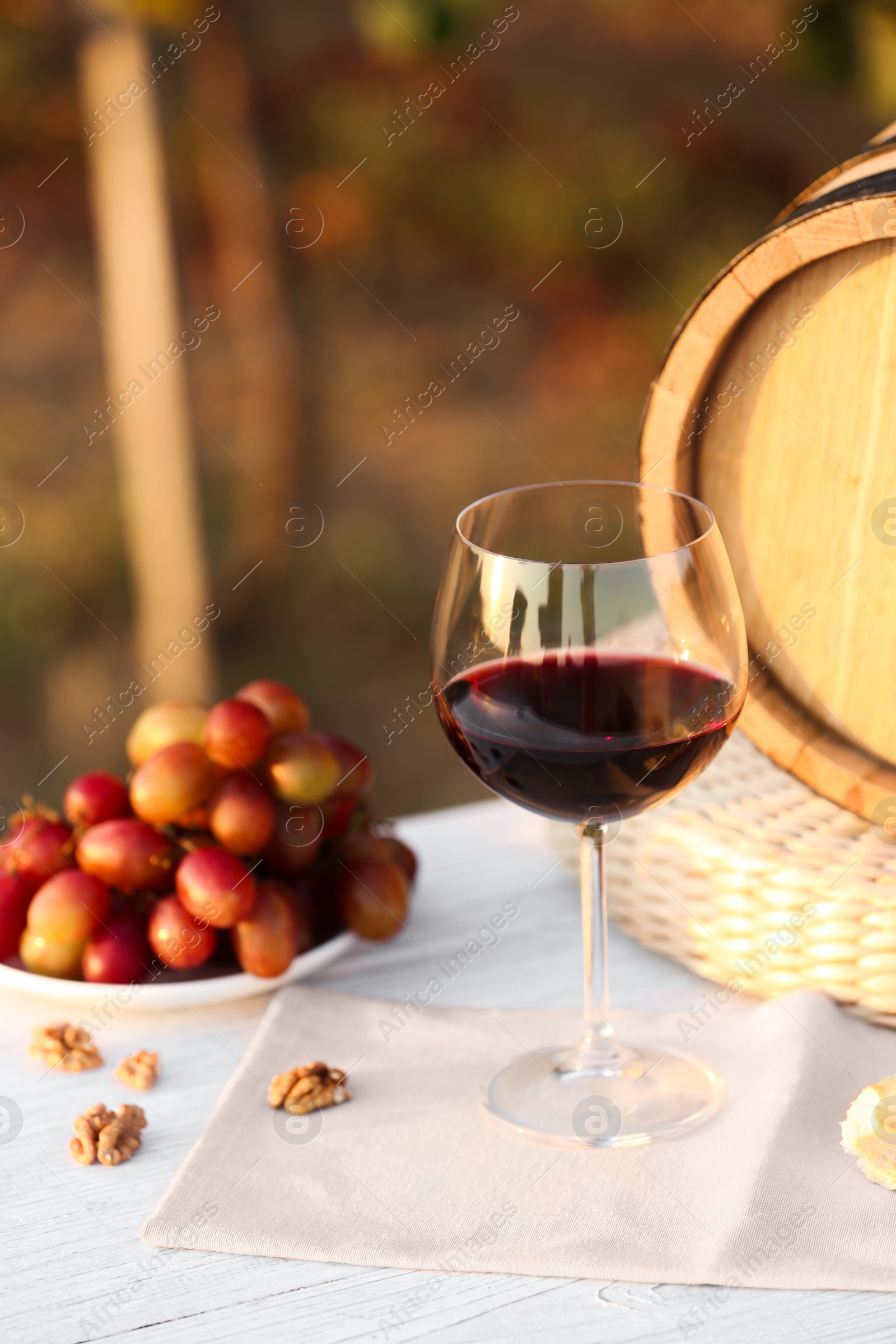 Photo of Composition with wine and snacks on white wooden table outdoors