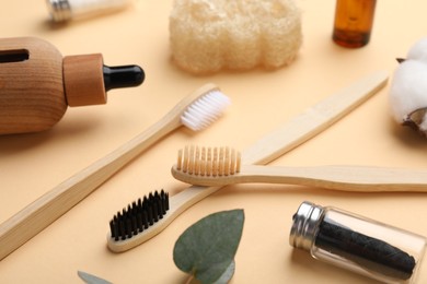 Composition with bamboo toothbrushes on pale orange background