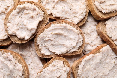 Many sandwiches with lard spread as background, top view
