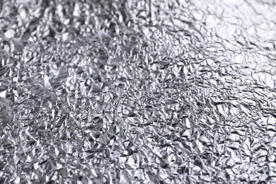 Crumpled silver foil as background, closeup view