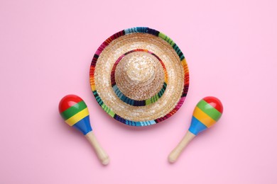 Photo of Colorful maracas and sombrero hat on pink background, flat lay. Musical instrument