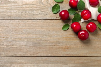 Fresh ripe cherry plums on wooden table, flat lay. Space for text