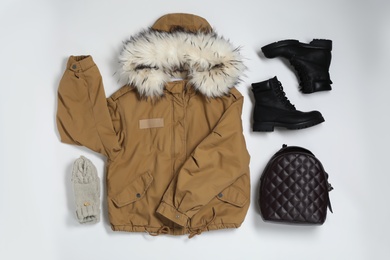 Flat lay composition with female winter clothes on white background