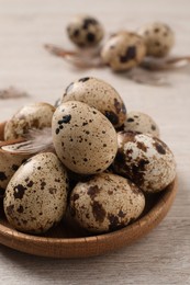 Photo of Fresh quail eggs on white wooden table, closeup