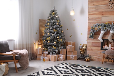 Stylish room interior with beautiful Christmas tree and gift boxes