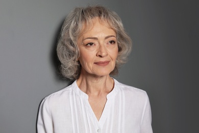 Photo of Portrait of mature woman on grey background