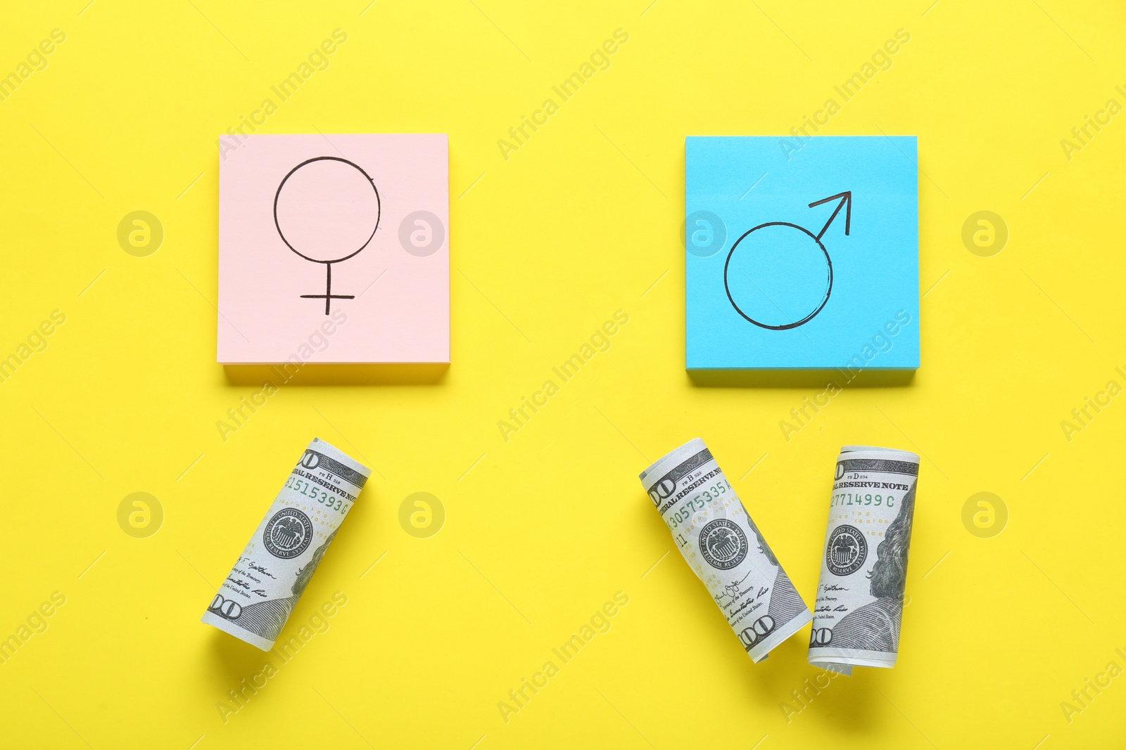 Photo of Gender pay gap. Paper notes with symbols and dollar banknotes on yellow background, flat lay