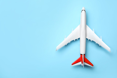 Top view of toy plane on blue background, space for text. Logistics and wholesale concept