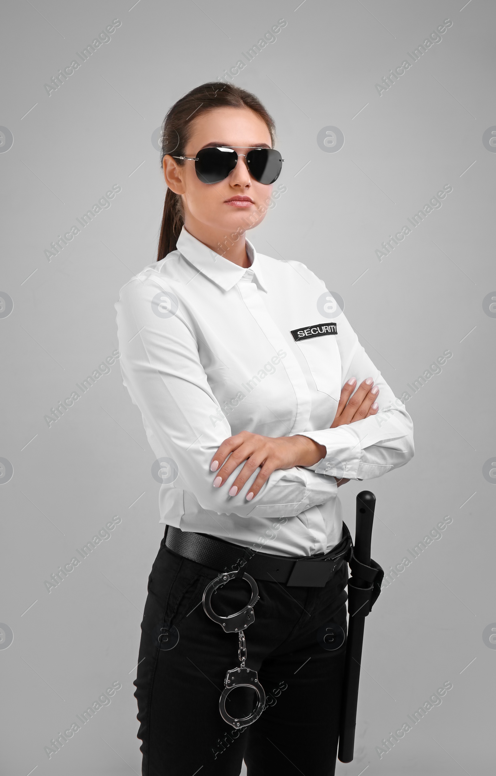 Photo of Female security guard in uniform on color background